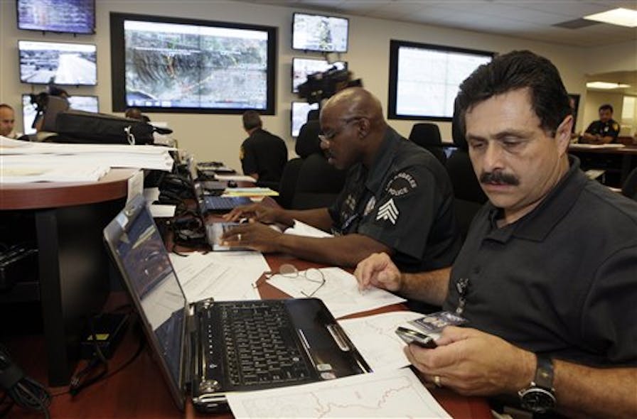 LAPD Capt. Philip Fontanetta, right, commanding officer, checks resources during the closure.