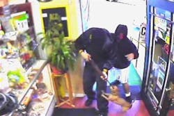 In a photo made from a surveillance video, a chihuahua jumps during a robbery.