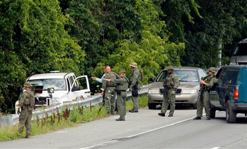 Law enforcement officials prepare to search the woods on Baltimore-Washington Parkway in Linthicum.