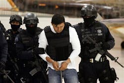 Federal Police agents escort Jesus Enrique Aguilar in Mexico City. Federal Police agents escort Jesus Enrique Aguilar in Mexico City.