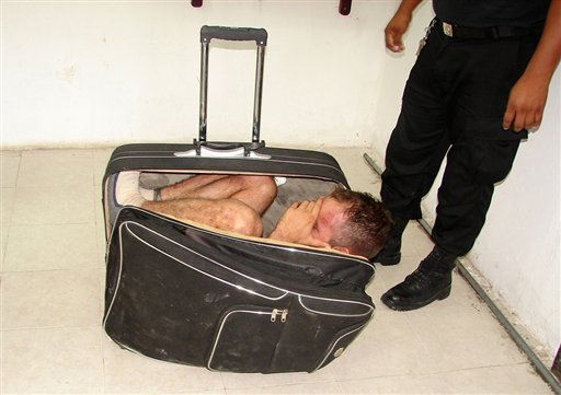In this photo taken Saturday, July 2, 2011, prison inmate Juan Ramirez Tijerina is curled inside a suitcase.