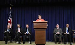 Homeland Security Secretary Janet Napolitano, center, delivers her remarks at the White House.