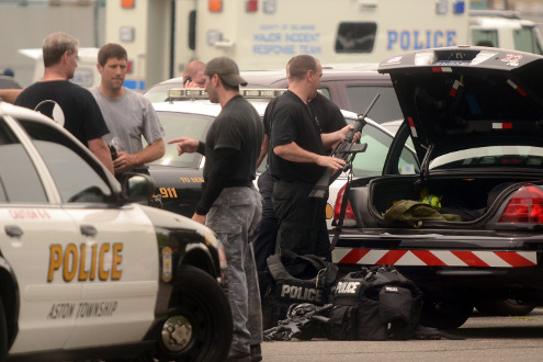 Police SWAT team members put away their gear after a stand off in Trainer.