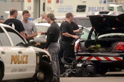 Police SWAT team members put away their gear after a stand off in Trainer. Police SWAT team members put away their gear after a stand off in Trainer.