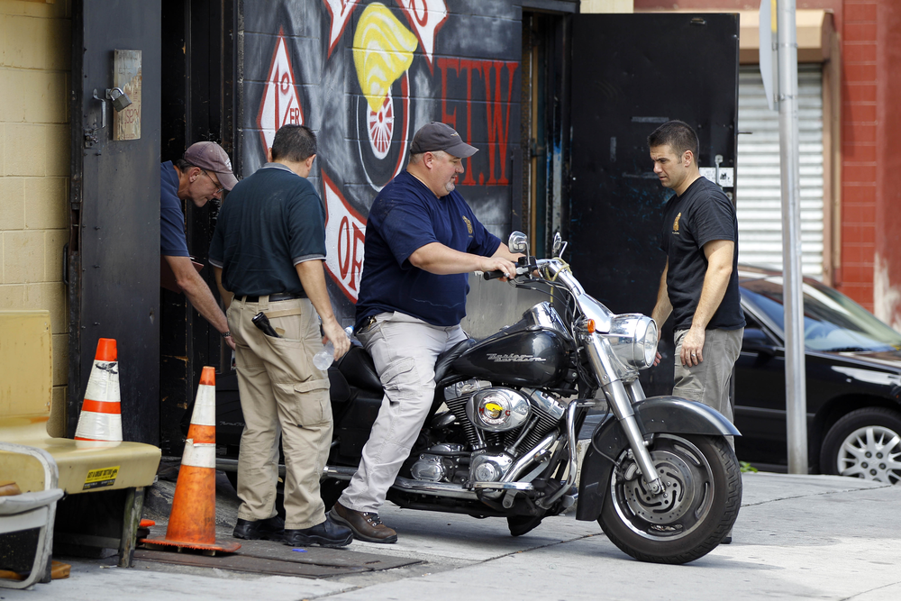 Investigators remove a motorcycle from a Wheels of Soul club location in Philadelphia.