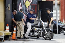 Investigators remove a motorcycle from a Wheels of Soul club location in Philadelphia. Investigators remove a motorcycle from a Wheels of Soul club location in Philadelphia.