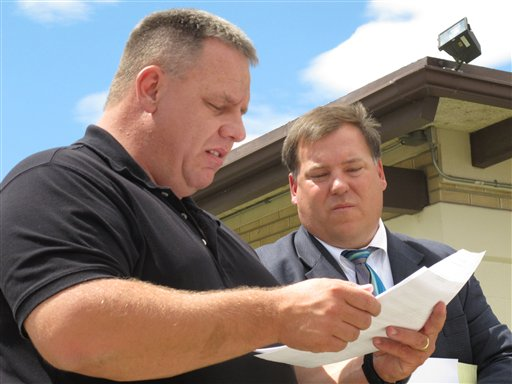 Wheatland, Wyo., Police Chief Randy Chesser, left, and Platte County Prosecuting Attorney Eric Jones, are shown discussing the shooting.