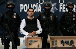Jose Antonio Acosta Hernandez, 33, is presented to the media by federal police officers in Mexico City. Jose Antonio Acosta Hernandez, 33, is presented to the media by federal police officers in Mexico City.