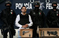 Jose Antonio Acosta Hernandez, 33, is presented to the media by federal police officers in Mexico City.