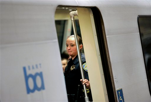 A BART transit police officer rides a train though San Francisco's Civic Center station on Aug. 13.