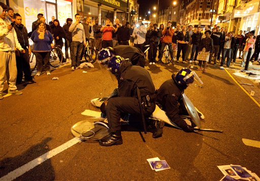 Police arrest a man for looting in Clapham Junction in south London.