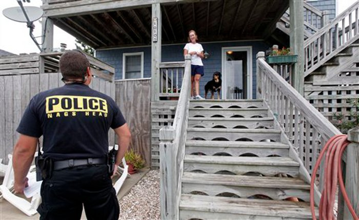 Nags Head Officer Edward Mann speaks with resident Debbie Hickey about Hurricane Irene.