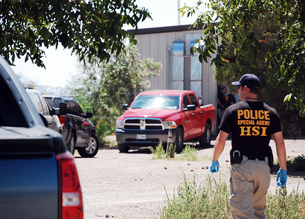 An unidentified DHS agent walks toward the cargo opening of New Deal Shooting Sports.