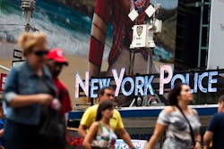 Pedestrians start their morning under the watchful eyes of surveillance cameras in Times Square. Pedestrians start their morning under the watchful eyes of surveillance cameras in Times Square.