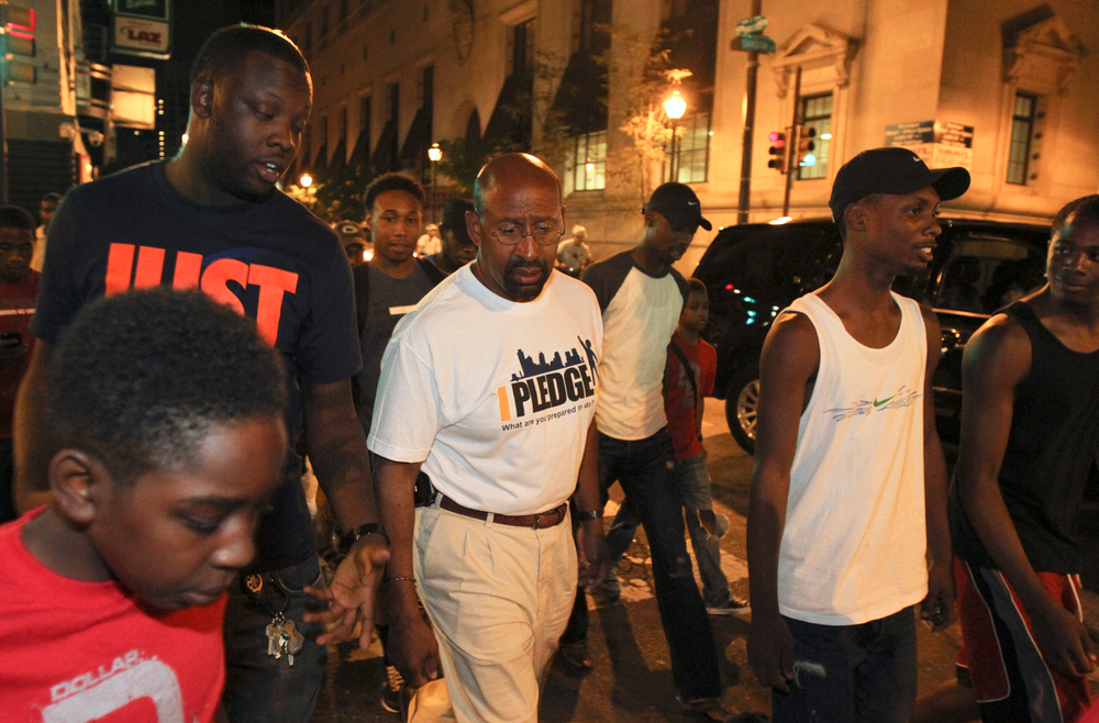 Philadelphia Mayor Michael Nutter walks with community leaders and several teens in the Center City neighborhood.