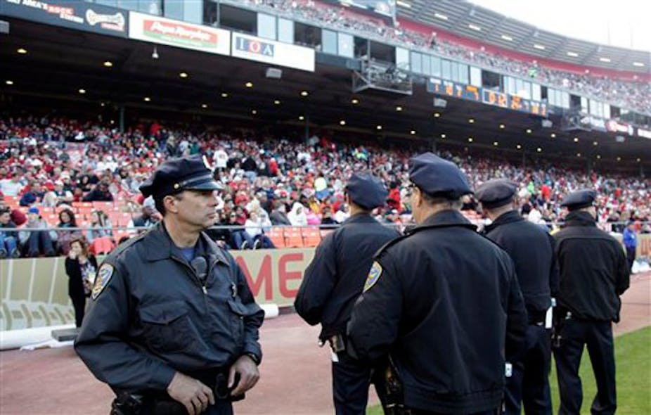 San Francisco police officers watch the crowd from the field during a preseason NFL football game.