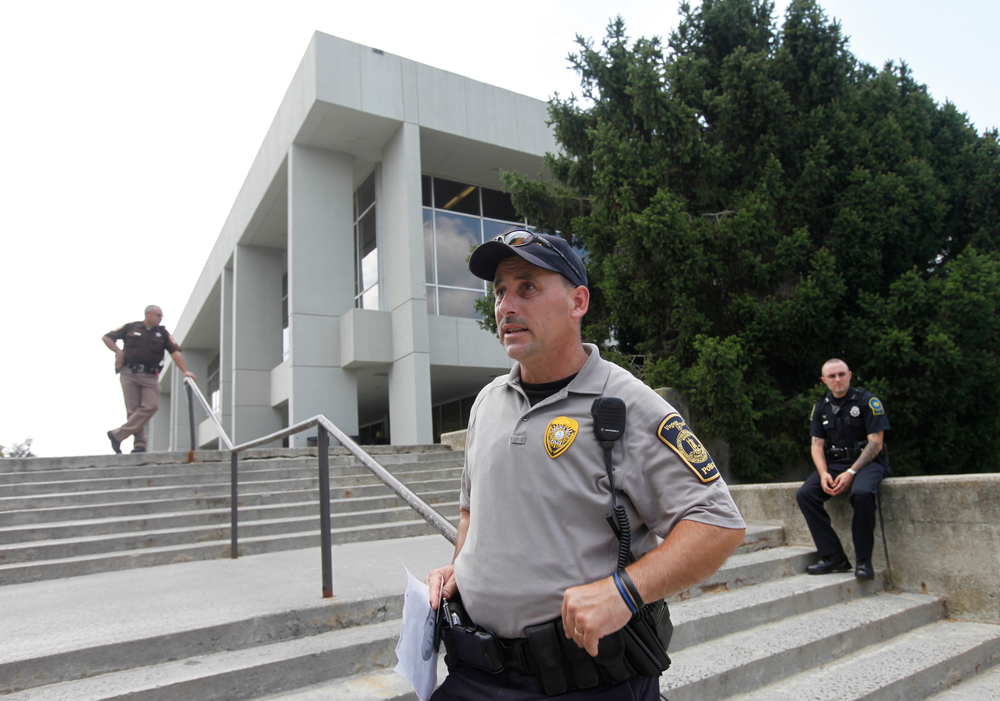 Law enforcement officers watch over Dietrick Hall after a lockdown of the campus was lifted.