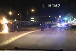 The video shows officers pulling people out from a burning car. The video shows officers pulling people out from a burning car.