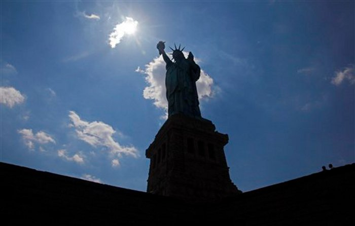 The Statue of Liberty is caught in an afternoon silhouette on Liberty Island in New York harbor.