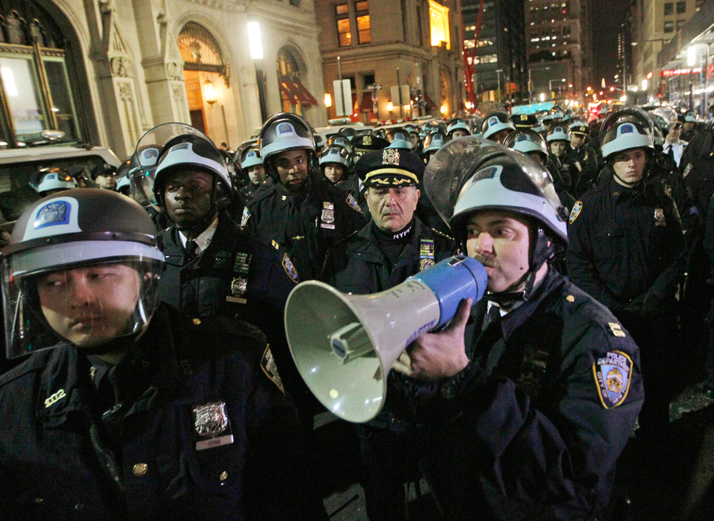 In this Nov. 15, 2011 file photo, officers disperse Occupy Wall Street protesters near the encampment at Zuccotti Park in New York.