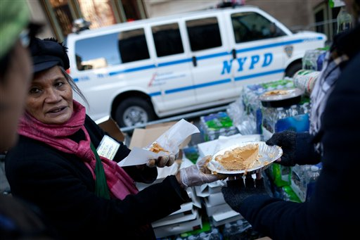 An Occupy Wall Street protestor serves pumpkin pie to demonstrators and pedestrians alike for Thanksgiving dinner in Zuccotti Park, Thursday, Nov. 24, 2011, in New York.