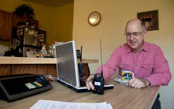 Scanner hobbyist Rick Hansen holds his scanner/Ham radio device at his home Saturday, Nov. 19, 2011, in Silver Spring, Md. Scanner hobbyist Rick Hansen holds his scanner/Ham radio device at his home Saturday, Nov. 19, 2011, in Silver Spring, Md.