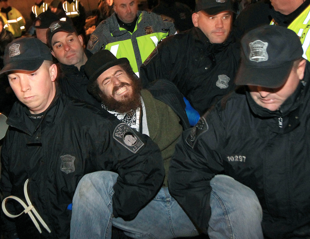 Boston police officers remove an Occupy Boston protester from Dewey Square in Boston before dawn Saturday, Dec. 10, 2011. More than 40 people were peacefully arrested as the park was cleared.