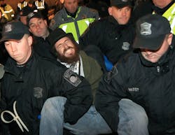 Boston police officers remove an Occupy Boston protester from Dewey Square in Boston before dawn Saturday, Dec. 10, 2011. More than 40 people were peacefully arrested as the park was cleared. Boston police officers remove an Occupy Boston protester from Dewey Square in Boston before dawn Saturday, Dec. 10, 2011. More than 40 people were peacefully arrested as the park was cleared.
