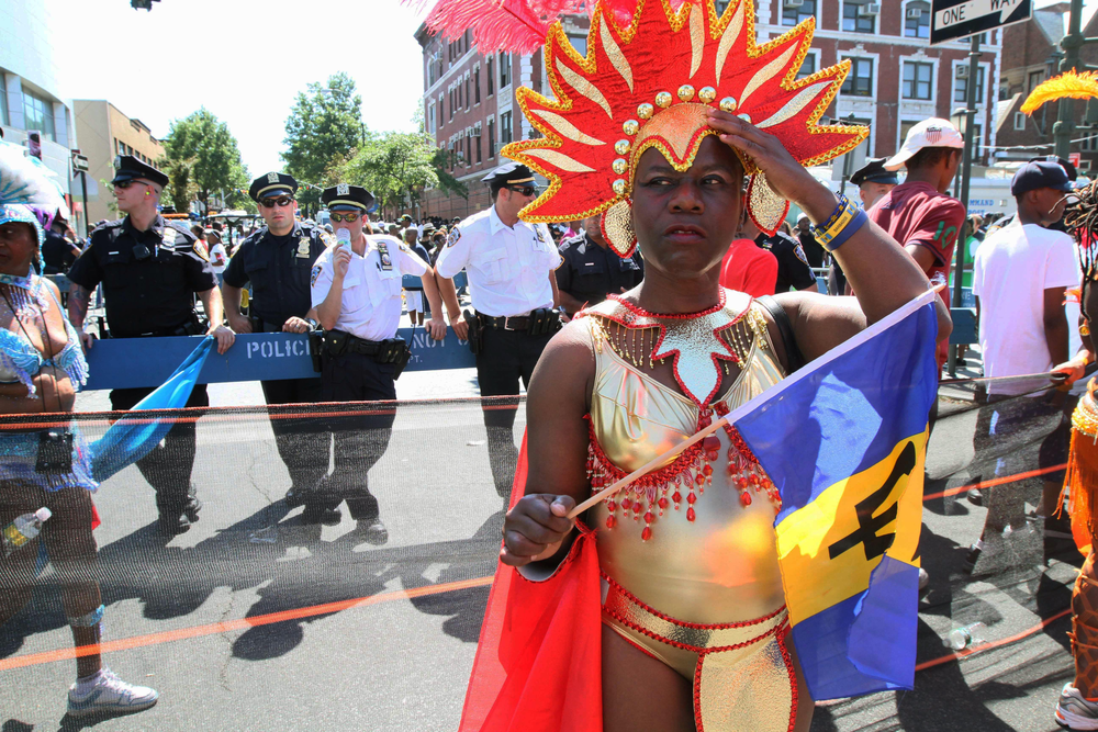 In this Sept. 26, 2010 photo, police stand along the route of the West Indian-American Day Parade as parade participants make their way along Eastern Parkway in the Brooklyn borough of New York.
