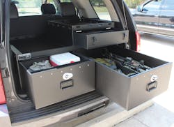 SUV outfitted with law enforcement weapons and gear in Hitec compartments SUV outfitted with law enforcement weapons and gear in Hitec compartments