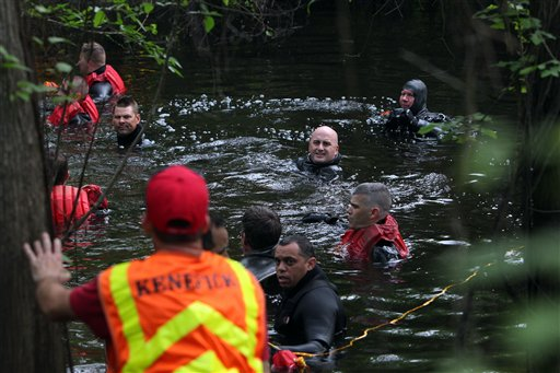 Houston police marine unit divers search for 2-year-old Devin Davis in a creek next to his home on Wednesday, March 28, 2012, in Cleveland, Texas.