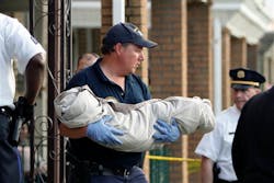 A crime scene unit member carries a body from a home in Northeast Philadelphia on Thursday May 24, 2012, where toddler twins were found dead in their home. Police say the 18-month-old boy and girl appear to have died of suffocation and the mother is in custody. Police say their 41-year-old mother attempted to take her own life by slitting her wrists and they believe she gave some kind of prescription pills to her 4-year-old daughter. The 4-year-old girl is hospitalized. Information on her condition wasn't available. A crime scene unit member carries a body from a home in Northeast Philadelphia on Thursday May 24, 2012, where toddler twins were found dead in their home. Police say the 18-month-old boy and girl appear to have died of suffocation and the mother is in custody. Police say their 41-year-old mother attempted to take her own life by slitting her wrists and they believe she gave some kind of prescription pills to her 4-year-old daughter. The 4-year-old girl is hospitalized. Information on her condition wasn't available.