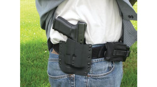 The Raven Concealment holster secures the author&apos;s Glock Model 23 with SureFire pistol light attached.