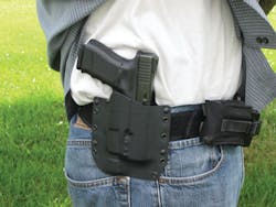 The Raven Concealment holster secures the author&apos;s Glock Model 23 with SureFire pistol light attached.
