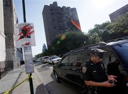 A New York City police officer guards the crime scene perimeter on New York's Lower East Side, Thursday, July 5, 2012, where a New York City police officer was shot in the building, background center.Police say the officer was hit in his bullet-proof vest Thursday morning on Essex Street. He was taken to Bellevue Hospital where he was listed in stable condition. A New York City police officer guards the crime scene perimeter on New York's Lower East Side, Thursday, July 5, 2012, where a New York City police officer was shot in the building, background center.Police say the officer was hit in his bullet-proof vest Thursday morning on Essex Street. He was taken to Bellevue Hospital where he was listed in stable condition.