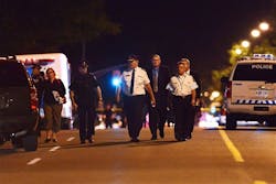 Toronto Police Chief Bill Blair, center, walks down Morningside Ave. in Toronto early Tuesday, July 17, 2012, following a shooting that left at least 19 people injured and two dead at a house party late Monday. The shooting took place after an altercation at an outdoor barbecue. Toronto Police Chief Bill Blair, center, walks down Morningside Ave. in Toronto early Tuesday, July 17, 2012, following a shooting that left at least 19 people injured and two dead at a house party late Monday. The shooting took place after an altercation at an outdoor barbecue.