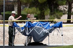 The body of a male chimpanze lies on the ground after being shot by police in Las Vegas, Nev., Thursday, July 12, 2012. Las Vegas Metro Police shot two chimpanzees on the loose killing one and tranquilizing the other. Metro spokesman Officer Marcus Martin said the chimp that was killed was shot by an officer after it appeared the chimp was headed toward residents, including children, who had come outside to watch the chase. The body of a male chimpanze lies on the ground after being shot by police in Las Vegas, Nev., Thursday, July 12, 2012. Las Vegas Metro Police shot two chimpanzees on the loose killing one and tranquilizing the other. Metro spokesman Officer Marcus Martin said the chimp that was killed was shot by an officer after it appeared the chimp was headed toward residents, including children, who had come outside to watch the chase.