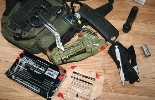 Examples of some of the gear for your One Man Go Bag: tourniquet, pressure dressing, medical gauze, decompression needle, emergency sheers, etc.