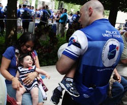 DJ Faulk of the Fairfax Co. PD meets up with his family, 7-month-old Bella, wife Roxy and nearly 3-year-old son Jackson at the National Law Enforcement Officers Memorial after biking 230 miles for charity. DJ Faulk of the Fairfax Co. PD meets up with his family, 7-month-old Bella, wife Roxy and nearly 3-year-old son Jackson at the National Law Enforcement Officers Memorial after biking 230 miles for charity.