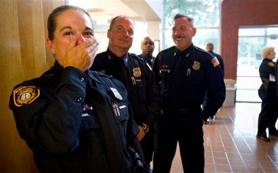 Memphis police officers Melissa Haley, from left, Paul French, Robert Hence and Mark Henderson react as they watch a photo slide show from their recently completed Basic Mounted Patrol School.