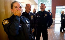 Memphis police officers Melissa Haley, from left, Paul French, Robert Hence and Mark Henderson react as they watch a photo slide show from their recently completed Basic Mounted Patrol School.