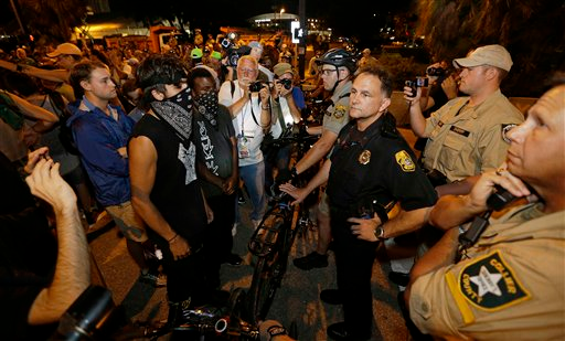 Tampa assistant police chief JA Bennett speaks with protestors, Thursday, Aug. 30, 2012, in Tampa, Fla. Protestors gathered in Tampa to march in demonstration against the Republican National Convention.