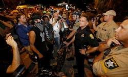 Tampa assistant police chief JA Bennett speaks with protestors, Thursday, Aug. 30, 2012, in Tampa, Fla. Protestors gathered in Tampa to march in demonstration against the Republican National Convention. Tampa assistant police chief JA Bennett speaks with protestors, Thursday, Aug. 30, 2012, in Tampa, Fla. Protestors gathered in Tampa to march in demonstration against the Republican National Convention.