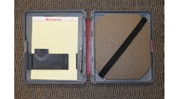 A storage notebook that holds paper, pen and the IIIA plate that could be used for protection during a traffic stop. Open.