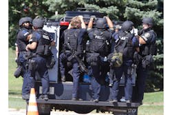 SWAT team members are seen at the Sikh Temple on S. Howell Ave. in Oak Creek, Wis. where a shooting occurred on Aug. 5.