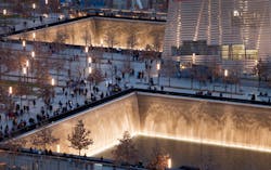 Visitors to the National September 11 Memorial in New York walk around its twin pools on Dec. 20, 2011.