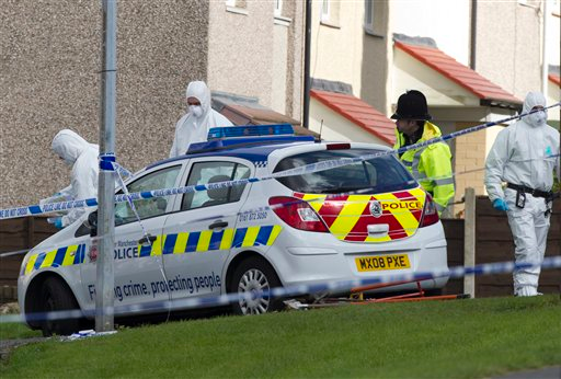 Police forensics staff work near the scene in Greater Manchester where two unarmed female police officers were killed in a gun and grenade attack, which led to the arrest of a wanted man. PC Nicola Hughes, 23, and PC Fiona Bone, 32, were killed to Abbey Gardens in Mottram near Manchester whilst investigating what turned out to be a false report of a burglary, in Manchester, England, Wednesday, Sept. 19, 2012.