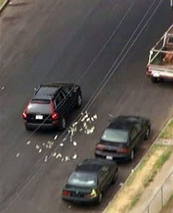 This image provided by KNBC-TV shows bank robbery suspects throwing money from their vehicle during a police pursuit Wednesday Sept. 12, 2012 in Los Angeles. The vehicle was eventually blocked by another vehicle and the suspects were arrested. This image provided by KNBC-TV shows bank robbery suspects throwing money from their vehicle during a police pursuit Wednesday Sept. 12, 2012 in Los Angeles. The vehicle was eventually blocked by another vehicle and the suspects were arrested.