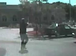 In this image taken from a Aug. 5, 2012 video from Oak Creek Police Lt. Brian Murphy&apos;s squad car camera, Lt. Murphy, the first officer on the scene, exchanges fire in the temple parking lot with shooter Wade Michael Page, rear right, as Page emerges from the temple. The video shows Murphy rolling behind a parked car for cover and Page chasing him down, firing multiple shots at him. Milwaukee County District Attorney John Chisholm says Murphy was hit 15 times. Page killed himself following a firefight with Officer Sam Lenda.