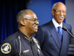 Assistant Police Chief and interim Chief Chester Logan speaks during a news conference as Detroit Mayor Dave Bing listens, in Detroit on Monday, Oct. 8, 2012. Bing announced the retirement of embattled Police Chief Ralph L. Godbee Jr. on Monday amid a scandal surrounding the top cop&apos;s alleged relationship with a subordinate female police officer.